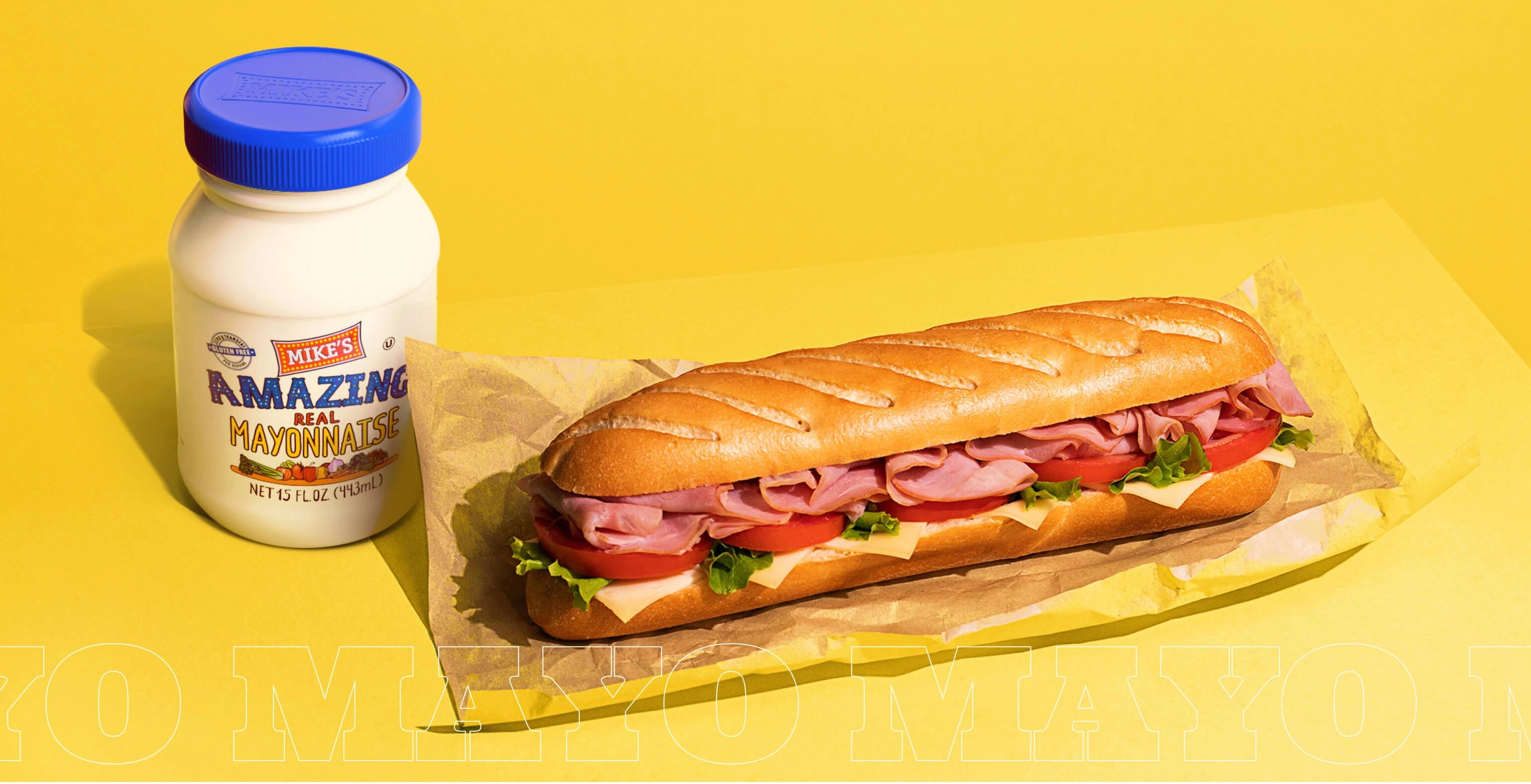 Mike's Amazing Mayonnaise next to a tasty sandwich.